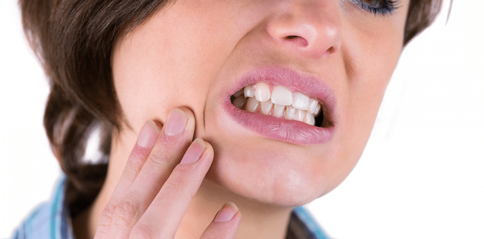 Person holding jaw and experiencing pain from a cracked or broken tooth requiring urgent dental treatment at Oral Dental Square Tarneit