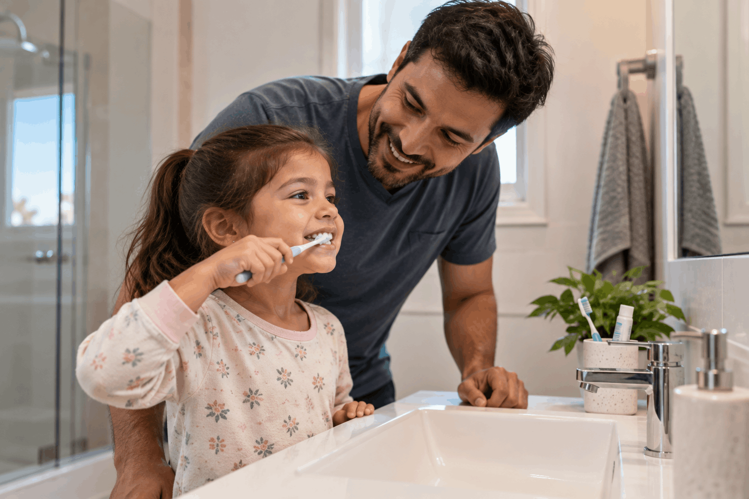 Child brushing teeth with a parent at home in Tarneit